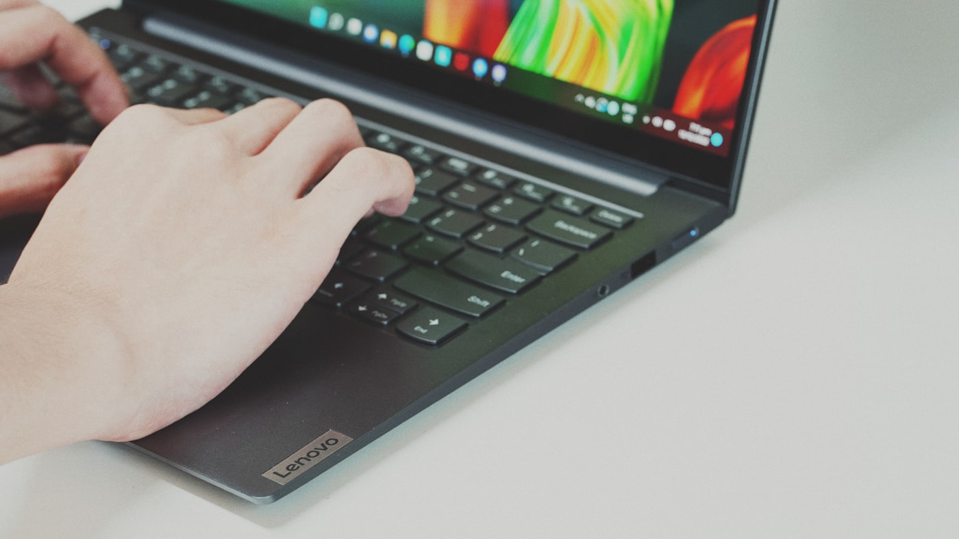 Hands typing on a laptop for remote work